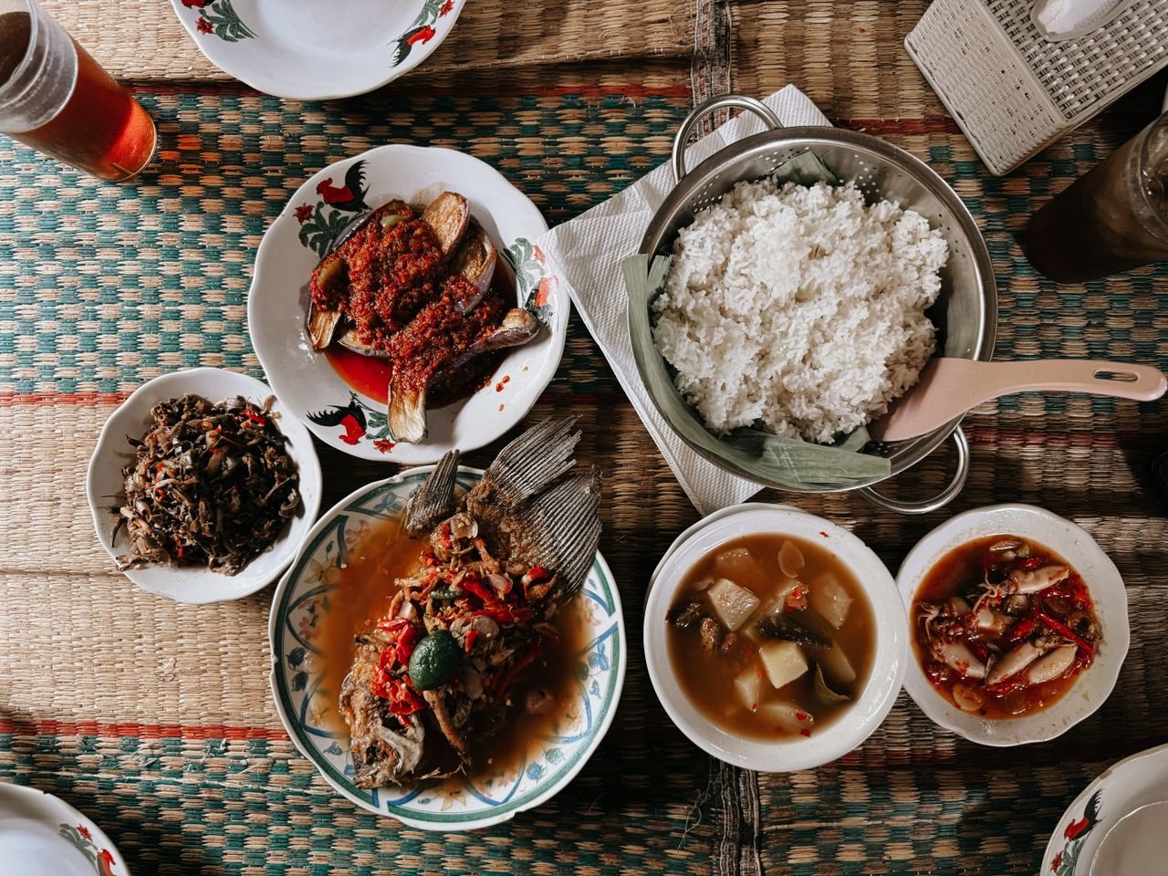 A traditional Indonesian meal arrangement with rice and assorted dishes in Jakarta.
